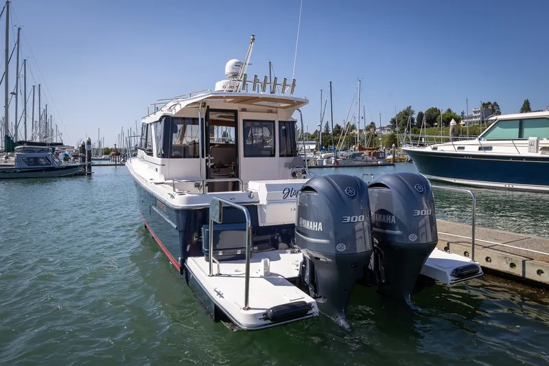 Slide: The Image of 2021 Cutwater C-32 Coupe boat docked with twin Yamaha 300 engines. - 1