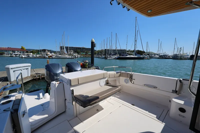 Slide: The Image of 2021 Cutwater C-32 Coupe boat docked at marina with clear blue sky. - 6