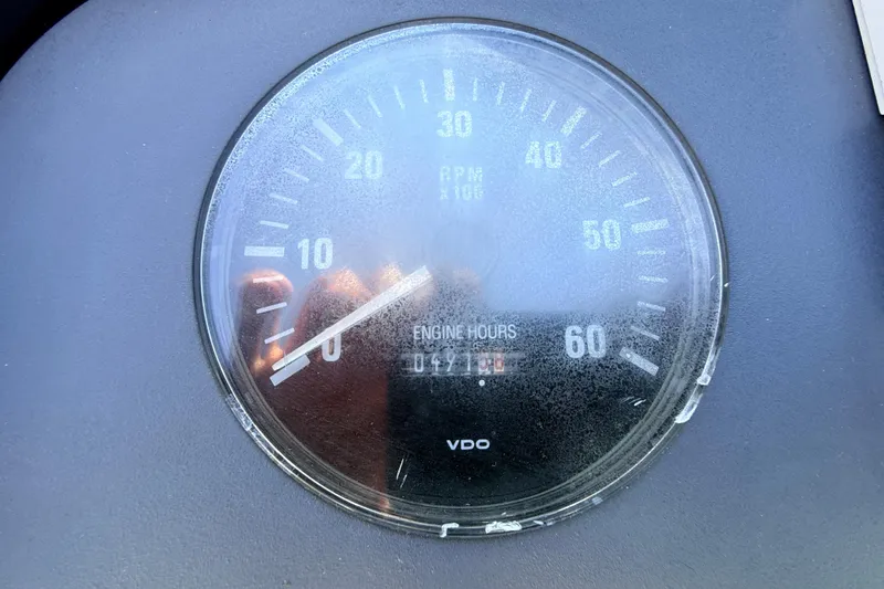 Slide: The Image of Close-up of a 1995 Formula 303 SR-1 tachometer showing engine hours and RPM. - 12