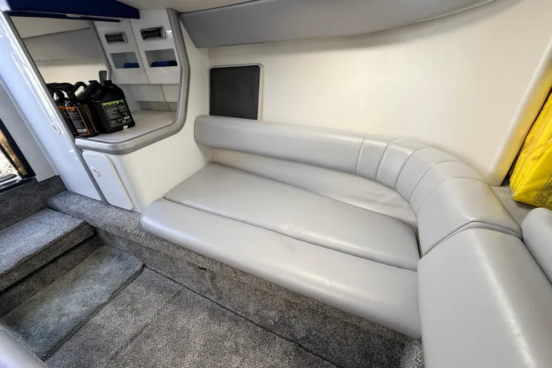 Slide: The Image of Interior of a 1995 Formula 303 SR-1 boat with gray seating and carpeted flooring. - 29