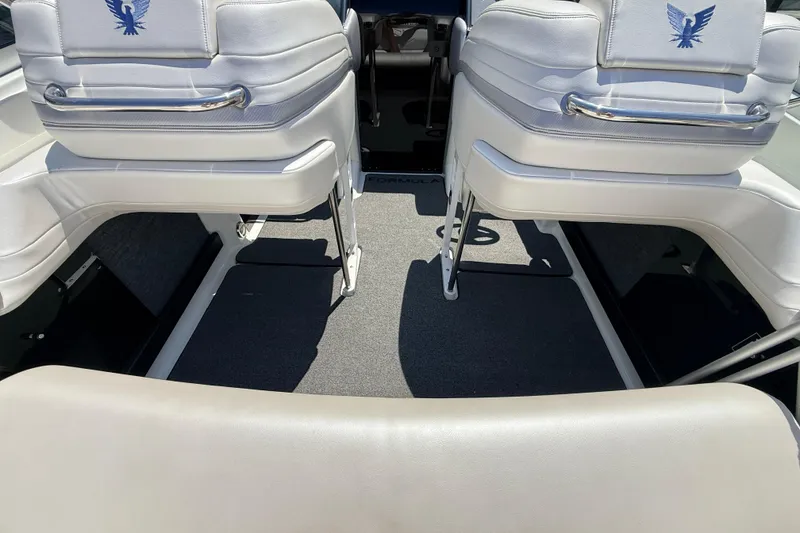 Slide: The Image of Interior of a 1995 Formula 303 SR-1 boat with white seating and carpeted floor. - 23