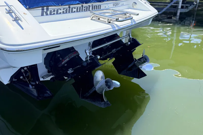 Slide: The Image of Rear view of a 1995 Formula 303 SR-1 boat with dual propellers in water. - 6