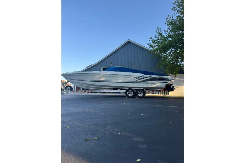 Slide: The Image of 1995 Formula 303 SR-1 boat on trailer, parked near a building. - 8