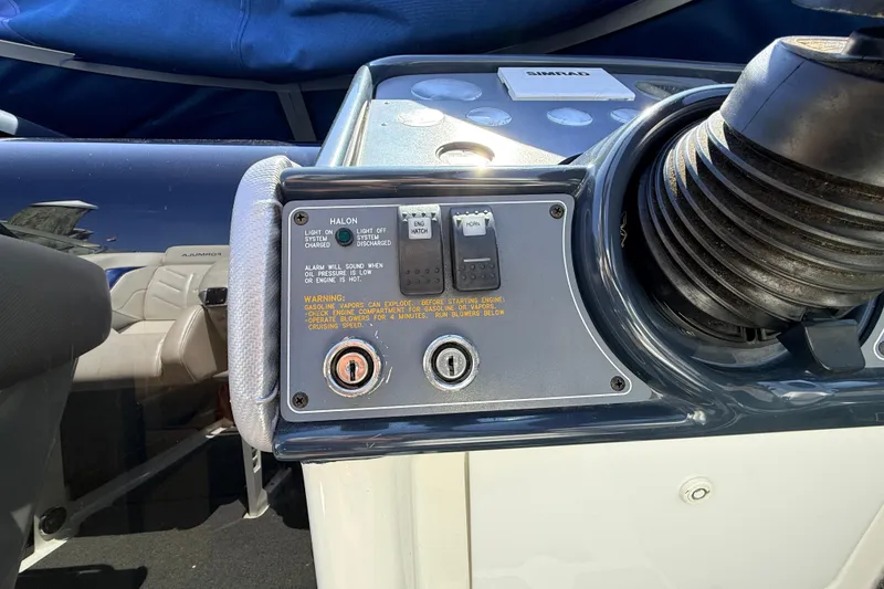 Slide: The Image of Control panel of a 1995 Formula 303 SR-1 boat with warning labels and switches. - 15