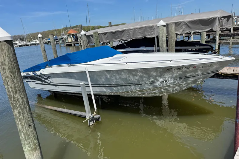 Slide: The Image of 1995 Formula 303 SR-1 boat docked with blue cover at marina. - 11