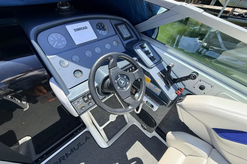 Slide: The Image of Cockpit of 1995 Formula 303 SR-1 boat with steering wheel and control panel. - 14