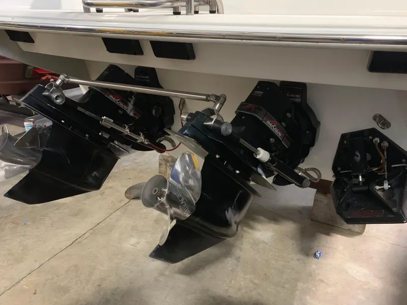 Slide: The Image of The image shows the drives of a 1995 Formula 303 SR-1 boat in a workshop. - 42