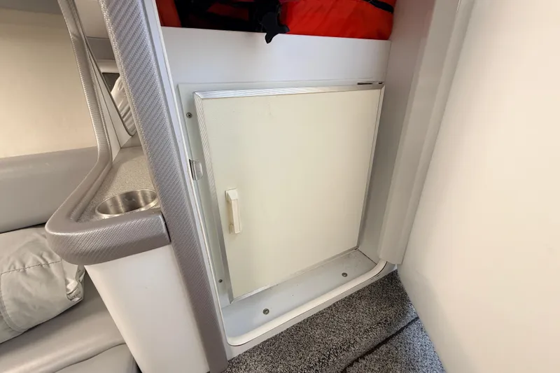 Slide: The Image of Interior of a 1995 Formula 303 SR-1 boat showing a compact cabin storage area. - 26