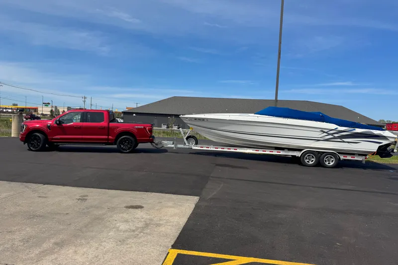 Slide: The Image of Red truck towing a 1995 Formula 303 SR-1 boat on a trailer in a parking lot. - 9