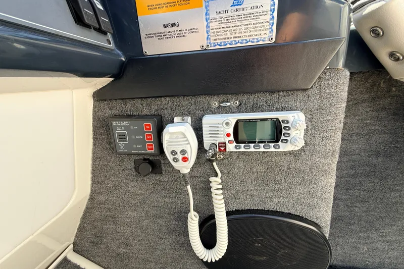 Slide: The Image of Control panel and radio equipment on a 1995 Formula 303 SR-1 boat dashboard. - 16