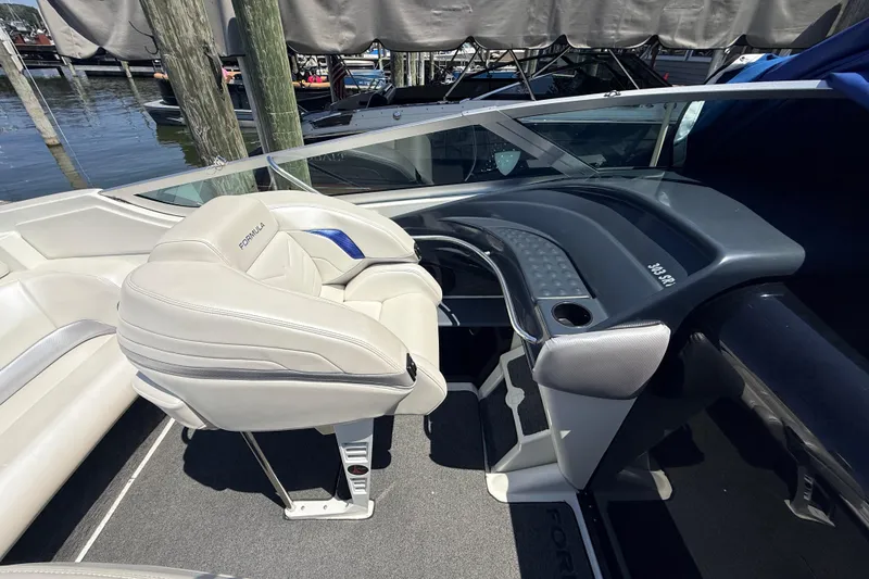 Slide: The Image of Interior of a 1995 Formula 303 SR-1 boat with white seating and dashboard. - 19