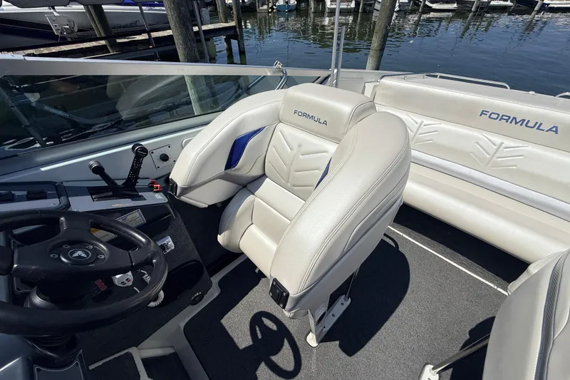 Slide: The Image of Interior of a 1995 Formula 303 SR-1 boat with steering wheel and seating. - 21