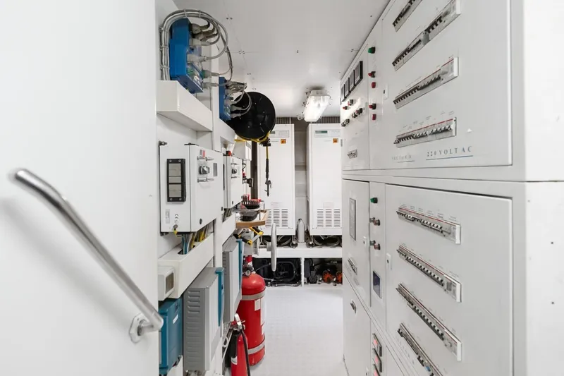 Slide: The Image of Electrical control room of a 2011 Ferretti Yachts 97, featuring panels and equipment. - 66