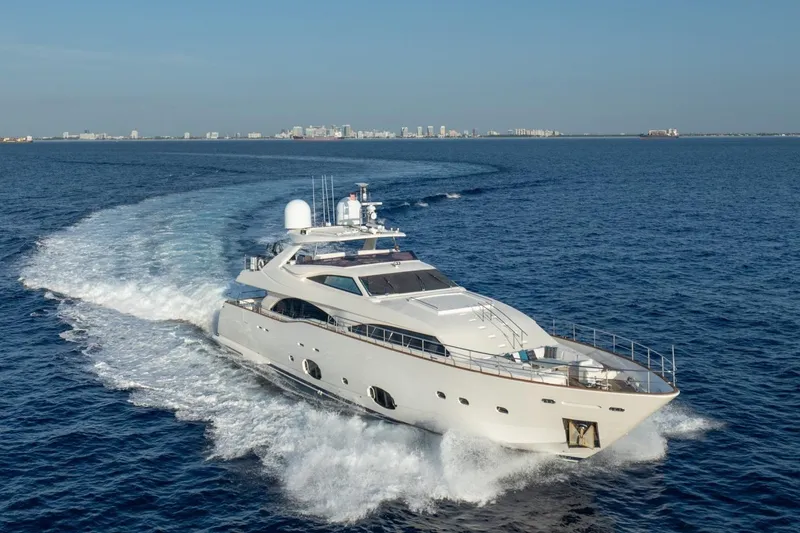 Slide: The Image of Luxury 2011 Ferretti Yachts 97 cruising on open sea with city skyline backdrop. - 3