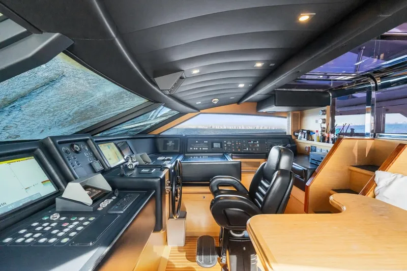 Slide: The Image of Luxurious helm of 2011 Ferretti Yachts 97, featuring advanced navigation controls and plush seating. - 20