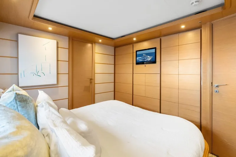 Slide: The Image of Luxurious bedroom interior of 2011 Ferretti Yachts 97, featuring modern design and elegant wood paneling. - 34