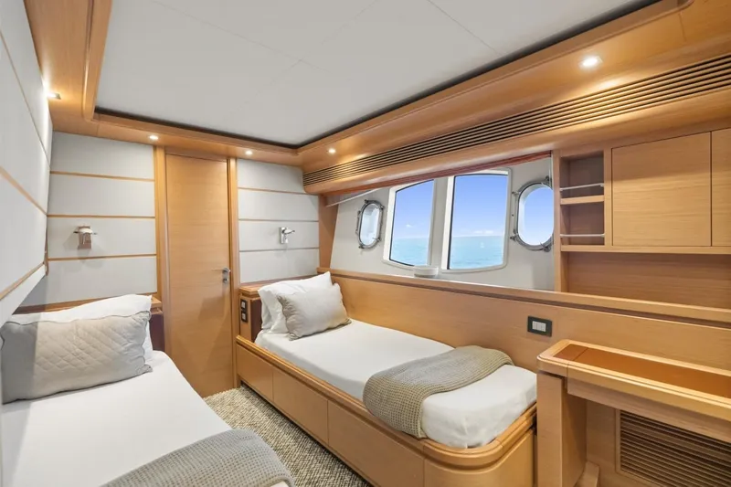 Slide: The Image of Luxurious twin cabin interior of 2011 Ferretti Yachts 97, featuring elegant wood finishes and ocean view. - 35