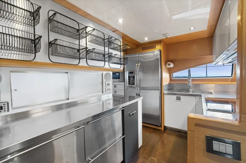 Slide: The Image of Modern kitchen interior on 2011 Ferretti Yachts 97, featuring stainless steel appliances and ocean view. - 21