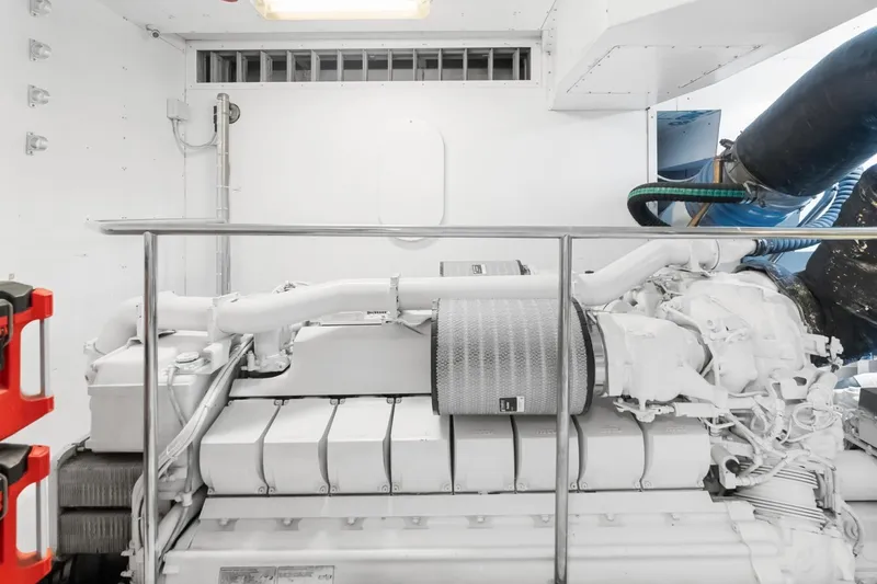 Slide: The Image of Engine room of a 2011 Ferretti Yachts 97, showcasing a powerful marine engine. - 67