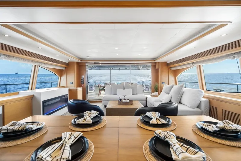 Slide: The Image of Luxurious interior of 2011 Ferretti Yachts 97, featuring elegant dining and seating areas with ocean views. - 14