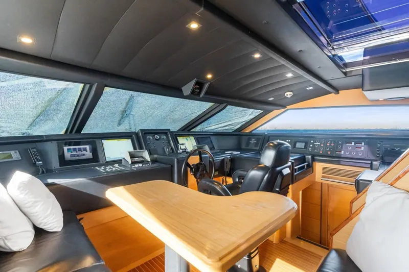 Slide: The Image of Luxurious helm of 2011 Ferretti Yachts 97, featuring modern navigation equipment and plush seating. - 18