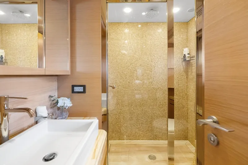 Slide: The Image of Luxurious bathroom on 2011 Ferretti Yachts 97, featuring elegant wood and mosaic tile design. - 40