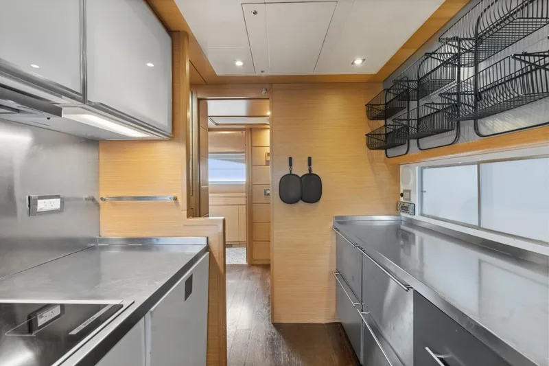 Slide: The Image of Modern kitchen interior of 2011 Ferretti Yachts 97, featuring sleek cabinetry and stainless steel surfaces. - 22