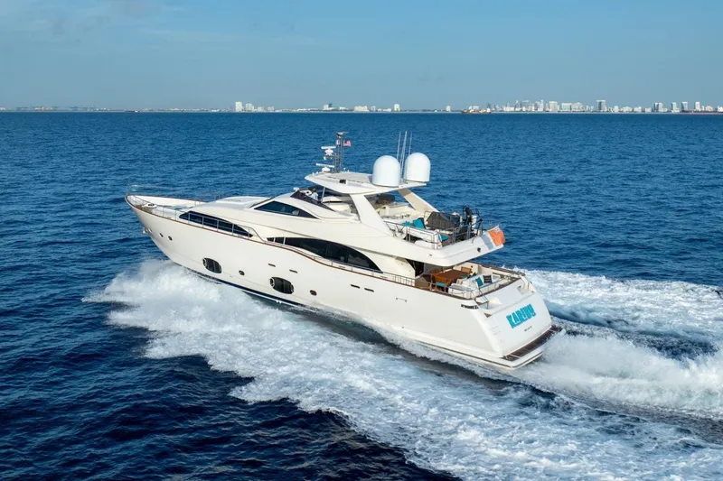Slide: The Image of Luxurious 2011 Ferretti Yachts 97 cruising on open sea, city skyline in background. - 2