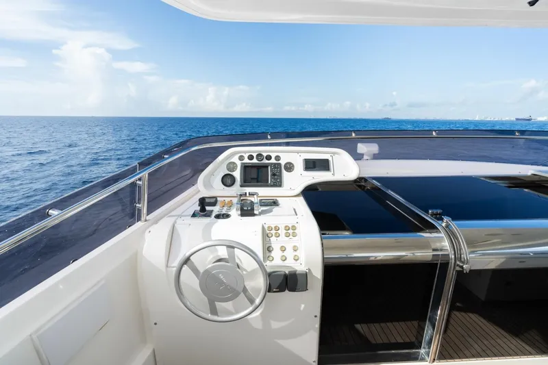 Slide: The Image of Cockpit view of 2011 Ferretti Yachts 97, overlooking the ocean under a clear blue sky. - 46