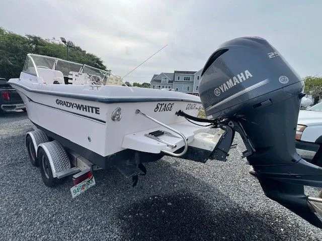 Slide: The Image of A 2003 Grady-White 225 Express boat on a trailer with a Yamaha outboard motor. - 3