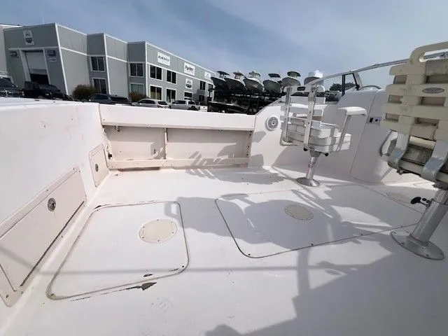 Slide: The Image of The image shows the deck of a 2003 Grady-White 225 Express boat. It is spacious and clean. - 6