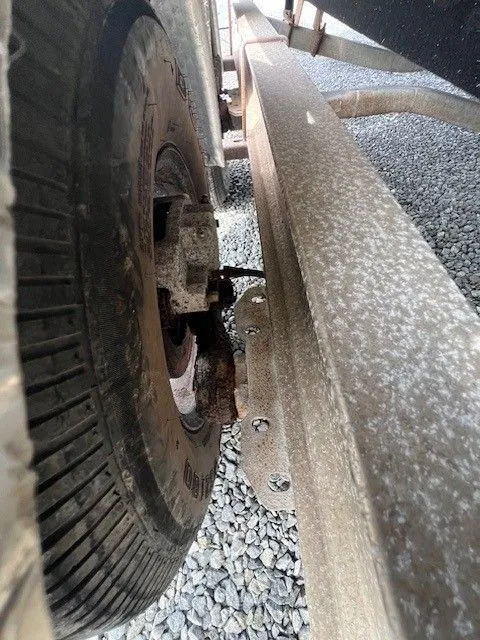 Slide: The Image of Close-up of a boat trailer with a wheel on a gravel surface. - 8