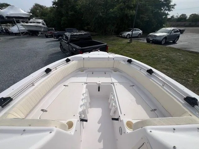 Slide: The Image of The image shows the bow of a 2003 Grady-White 225 Express boat with seating and cup holders. - 25