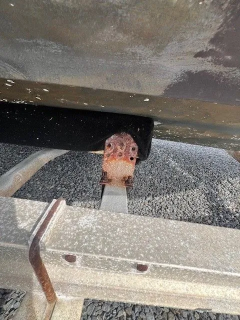 Slide: The Image of Close-up of a boat trailer with a rusty metal part. - 7