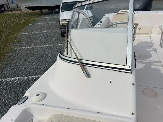 Slide: The Image of A 2003 Grady-White 225 Express boat with an open cockpit and windshield. - 19