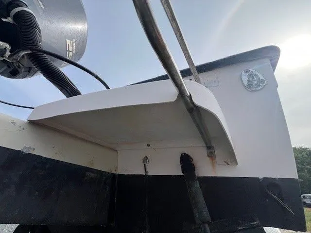 Slide: The Image of Close-up of the stern of a 2003 Grady-White 225 Express boat with motor. - 13