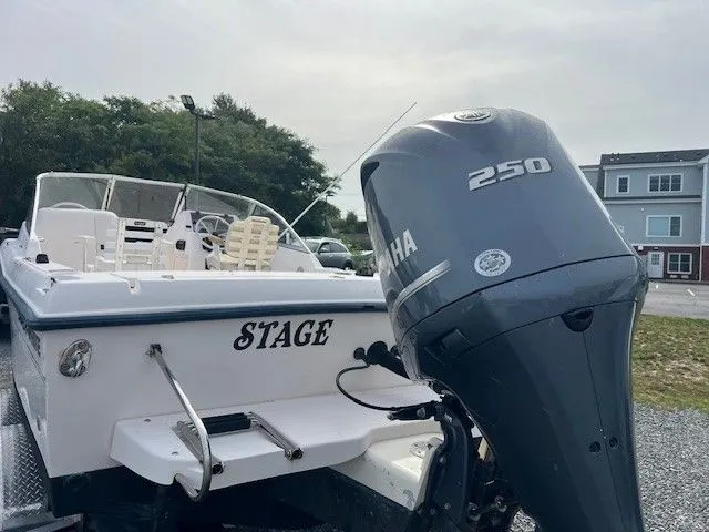 Slide: The Image of A 2003 Grady-White 225 Express boat with a Yamaha 250 outboard motor, parked on a trailer. - 15