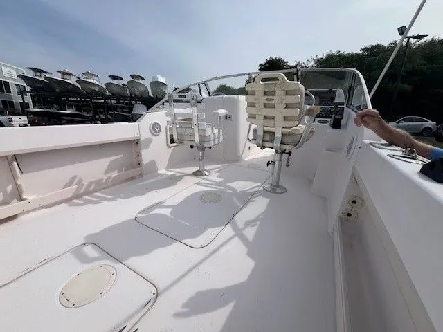 Slide: The Image of The image shows the deck of a 2003 Grady-White 225 Express boat with seating. - 5