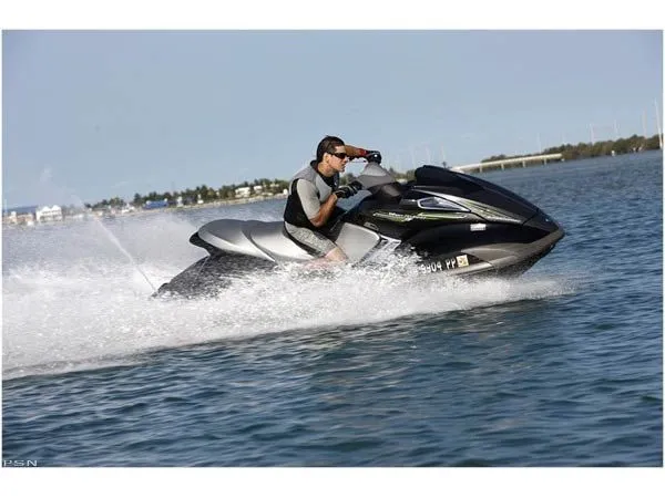 Slide: The Image of A man rides a 2009 Yamaha FX® SHO jet ski on the water. - 4