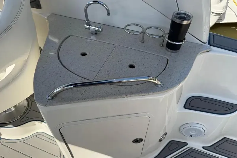 Slide: The Image of 2008 Sea Ray Sundancer 280 boat sink area with cup holders and faucet. - 13
