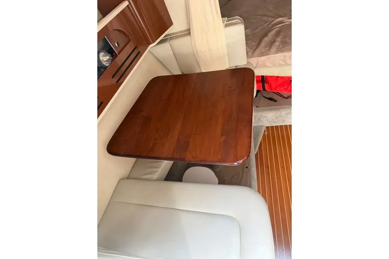 Slide: The Image of Interior of 2008 Sea Ray Sundancer 280 with wooden table and seating area. - 19
