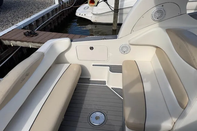 Slide: The Image of 2008 Sea Ray Sundancer 280 boat interior with beige seating and gray flooring. - 14