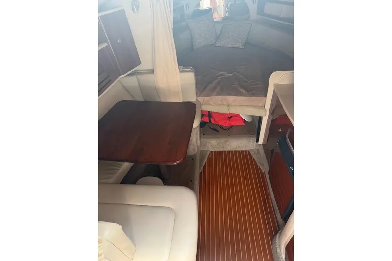 Slide: The Image of Interior of 2008 Sea Ray Sundancer 280 with cozy seating and wooden table. - 21