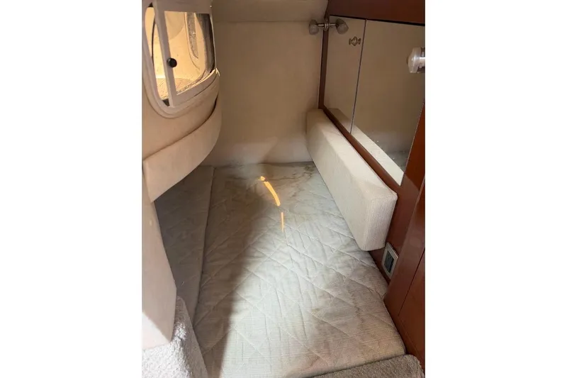 Slide: The Image of Interior cabin of 2008 Sea Ray Sundancer 280 with cushioned seating and mirrored wall. - 24
