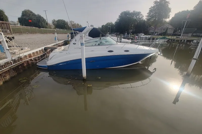 The Image of 2009 Sea Ray Sundancer 280 docked in a serene marina setting. - 0