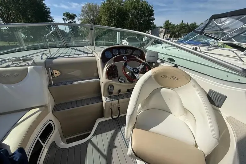 Slide: The Image of Cockpit of 2008 Sea Ray Sundancer 280 with steering wheel and dashboard controls. - 12