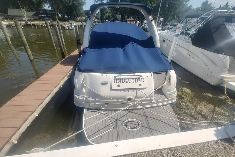 Slide: The Image of 2008 Sea Ray Sundancer 280 docked with blue cover and "Undecided" license plate. - 3
