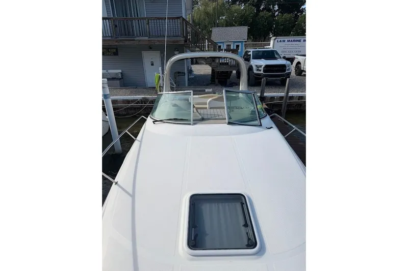 Slide: The Image of 2008 Sea Ray Sundancer 280 docked, showcasing sleek design and open deck layout. - 8