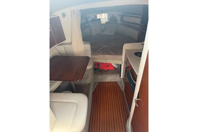 Slide: The Image of Interior of 2008 Sea Ray Sundancer 280, featuring cozy cabin with seating and bed. - 18