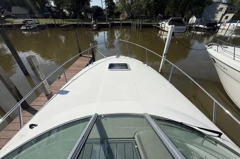 Slide: The Image of 2008 Sea Ray Sundancer 280 docked at a marina, view from the bow. - 9